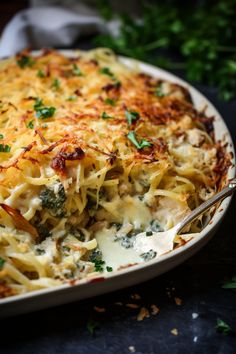 a casserole dish with broccoli, cheese and parmesan on top