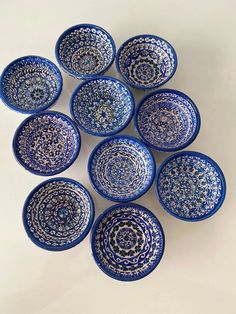 six blue and white bowls sitting on top of a table