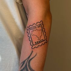 a man's arm with a stamp on it that says brazil and the map of brazil