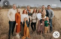 a family posing for a photo in a field