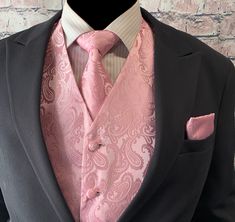 a man wearing a suit and pink tie