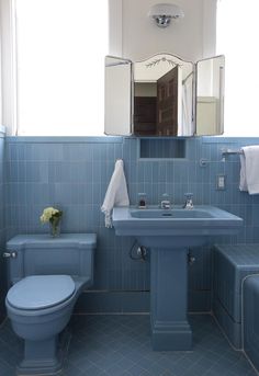 a bathroom with blue tile walls and floor