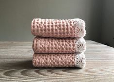 three pink towels stacked on top of each other