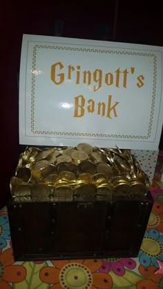 a trunk with gold coins in it and a sign that says grinott's bank