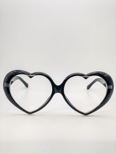 Oversized heart shaped clear lens glasses are a fun and fashionable accessory to wear this Valentine’s Day! The frames are oversized with a unique heart shape, making them a great statement piece to add to any outfit. With the clear lens, you can still show off your eye makeup and be able to see clearly! Heart Effect Glasses, Playful Heart-shaped Sunglasses With Gradient Lenses, Heart-shaped Sunglasses With Heart Print, Heart-shaped Sunglasses With Tinted Glass Lenses, Trendy Heart-shaped Glass Sunglasses, Cute Glasses Frames, Heart Shaped Glasses, Fashion Themes