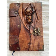 a wooden book with an image of a man's face in the middle of it