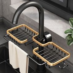 two black and gold sink faucets with towels hanging from them