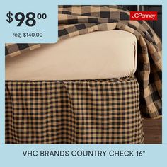 a bed with a black and white checkered bedspread next to a pillow