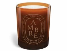 a candle that is sitting in front of a white background with the words ambre on it