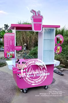 a pink and white ice cream kiosk on wheels