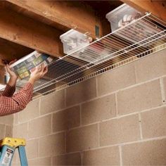 a man is working on the ceiling in his home