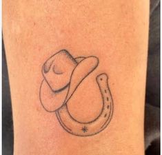 a tattoo with a cowboy hat and a horseshoe