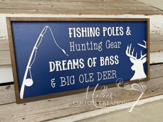 a sign on the side of a building that says fishing poles and hunting gear dreams of bass & big ole deer