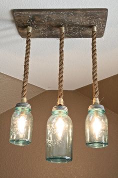 three mason jar lights hanging from the ceiling