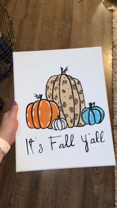 someone holding up a card that says it's fall y'all