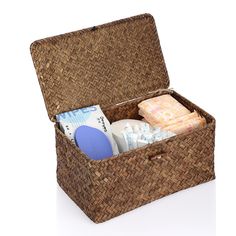 an open wicker box with soaps, lotion and other items in it