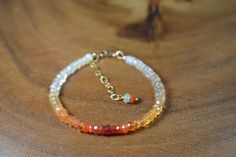 "These Gemstone Bracelets focus on the natural beauty of the featured gemstone. Made with only quality metals (sterling silver or 14k Gold Fill), the remainder of the bracelet is strictly gemstone. Delicate and Sparkly, your Loved one (or Yourself!) will absolutely fall in love with their beauty. This Gorgeous Mexican Fire Opal Bracelet is presented to you in 14k Gold. The beads are a moderate size, 4.25mm,  making for a lovely Everyday piece. The Bracelet displays the natural variety of Fire Opal in an Ombre fashion, with: soft whites, iridescent whites, yellows, oranges, and reds. In it, you will find beautiful speckles of rainbow flash. Fire Opal is associated with Abundance and Luck belongs to the Solar Plexus Chakra. It serves as the 14th Precious Stone Anniversary Gifts as well as th Fire Bracelet, Bracelet Displays, 14th Anniversary, October Birthstone Jewelry, Yellow Ombre, Mexican Fire Opal, Ombre Fashion, Bracelet Display, Beads Bracelet Design