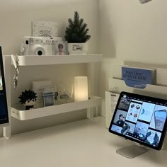 a tablet computer sitting on top of a desk next to a monitor screen and keyboard