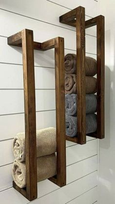 two wooden shelves holding towels in the bathroom