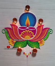 a colorful diya with lit candles on it