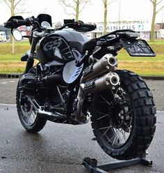 the motorcycle is parked on the pavement in the parking lot