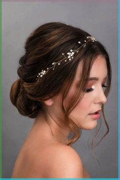 a woman wearing a bridal headpiece with flowers on it's side and hair comb in the back