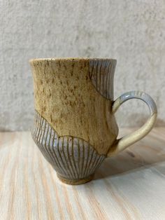 a coffee cup sitting on top of a wooden table