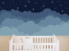 a baby's room with a crib and stars in the sky