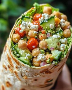 a burrito filled with chickpeas, cucumber and feta cheese