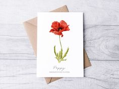 a card with a red flower on it