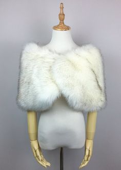 a white fur vest on a mannequin head