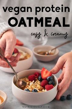 two bowls of oatmeal with berries and strawberries in them, one being spooned into the bowl