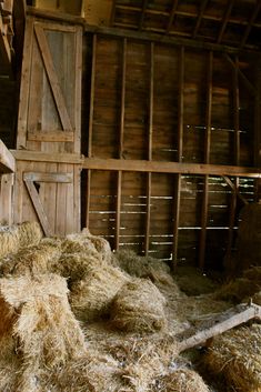 a barn with hay in the floor and walls