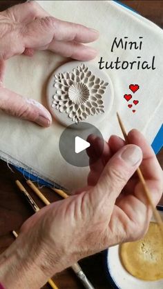 an older woman is working on crafts with her hands