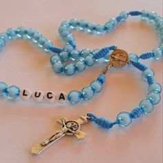 "Personalized boys rosary with blue beads. Send us a note in \"Add your personalization\" tab with the name or initials you want on rosary. As well as any other request. You can put rosary on neck and has a clasp so it will fit adults, teens and kids a like. Handwoven by our family in Medjugorje. Centerpiece and cross is Saint Benedict. Rosary lenght is 42 cm (16.5 inches) Beads size is 8 mm. Each rosary is made to order specially for you. Very light and can be worn in any occasion. Specially gr Adjustable Blue Rosary With Miraculous Medal, Handmade Blue Rosary With Cross Shape, Handmade Blue Rosary With Cross, Blue Cross Rosary For Gift, Blue Cross Rosary As Gift, Blue Rosary With Round Beads For Gift, First Communion Gifts For Boys, Communion Gifts For Boys, Confirmation Gifts For Boys