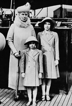 an old black and white photo of two women and a child on a boat deck