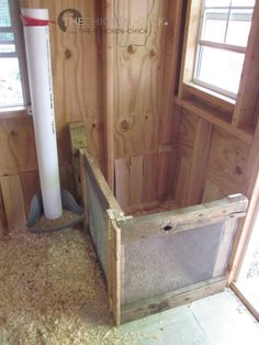 the inside of a building with wood walls and insulation tape on the floor next to a window