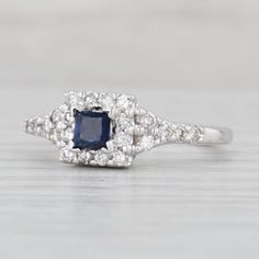 a blue and white diamond ring on a table