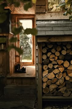 a pile of logs sitting in front of a window