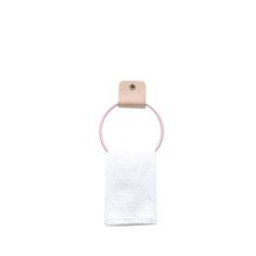 a white towel with a pink ring hanging from it's side on a white background