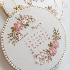 two embroidered hoops with flowers on them and the words happy birthday written in cursive writing