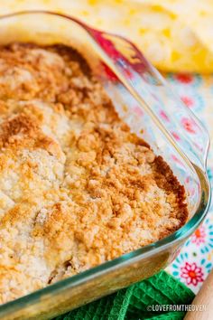 a casserole dish filled with some type of baked food on a colorful cloth