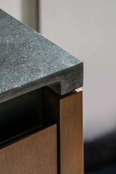 a close up view of the top of a table with wood and grey marble on it