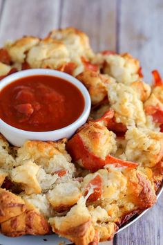 the homemade pizza monkey bread is ready to be eaten with sauce on top and in the middle