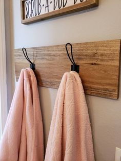 two towels are hanging on the wall next to a sign that says scrub - a - toe day