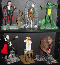 there are many halloween figurines on the shelves