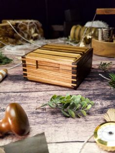 a wooden box sitting on top of a table next to other items and plants in front of it