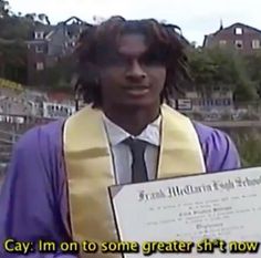 a young man wearing a graduation gown and holding a certificate