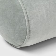 a close up view of the back of a pillow with a light blue cover on it