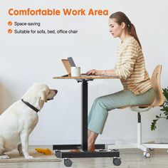 a woman sitting at a table with a dog on the floor in front of her